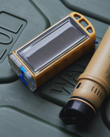 Solar-powered water purifier on a green case with a tan mobile charger next to it