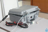 stream water device grey plastic case with tubing and connections coming out of it