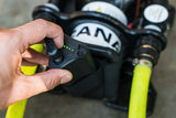 Black electronic device with a cord on a dark surface