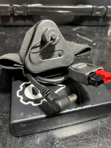 Black electronic device with a cord on a dark surface