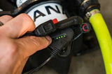 Hand connecting a black electronic device to a power cable