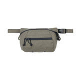 Green waist bag with a black zipper on a white background