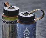Two water bottles with black lids on a textured surface
