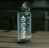 Clear water bottle with black lid featuring 'Cana Provisions' branding on a dark background.