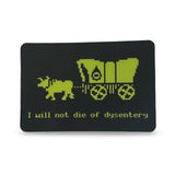 Black card with green illustration of a wagon and cow, and text 'I will not die of dysentery' on a white background.