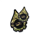A pair of cana provisions geardrop logo shaped stickers featuring a digital camouflage pattern, shown on a plain white background.