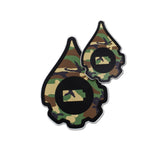 A pair of cana provisions geardrop logo shaped stickers featuring a camouflage pattern, shown on a plain white background.