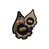 A pair of cana provisions geardrop logo shaped stickers featuring a tan digital type camouflage pattern, shown on a plain white background.