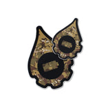 A pair of cana provisions geardrop logo shaped stickers featuring a digital type camouflage pattern, shown on a plain white background.