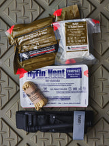 First aid supplies including a HyFin Vent chest seal on a textured surface