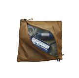 A tan mesh zippered pouch shown open, revealing packed gear inside, including a blue and white Cana Provisions bottle label. The pouch is photographed on a clean white background.