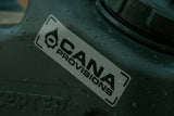 Cana Provisions logo sticker on a dark surface with water droplets