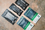 black and green medical kit packages on a textured surface