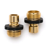 Two brass hose fitting connectors with black plastic parts on a white background