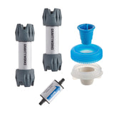 A GravityWorks water filter replacement kit on a white background, including two gray and white filter cartridges, a blue cone fitting, a blue filter head, a white plastic collar, and a small tubular carbon element