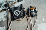 Pump and hose setup on a concrete floor with visible branding.