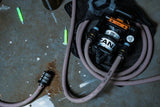 water pump with hoses on a concrete floor with glow sticks in the background