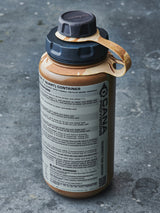 tan water bottle with camouflage-patterned cap strap on a gray surface