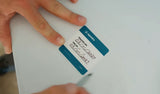 aquamira drops treatment record label shown with writing on it and being affixed to a white IBC tote with hands 
