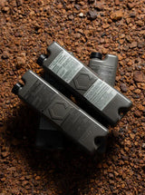 four iceflask tactical water bottles on a dirt background