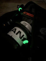Green glow beads on a dark surface.