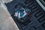 collection of assorted cana provisions water treatment and purification tools inside of a black mesh pouch on a black background