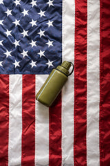 Green modcan water bottle on an American flag