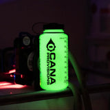 Glow-in-the-dark water bottle with 'Cana Provisions' branding on a dark background.