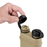 Hand opening a black cap on a tan charging device against a white background