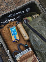 Outdoor survival kit with tools in a green case.