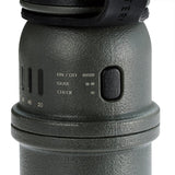 Close-up of a green cylindrical device with control buttons on a white background