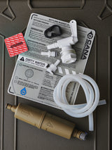 Water filtration system components on a green surface with labels and instructions.