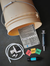 Bucket with water treatment components on a dark surface