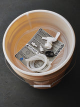 Bucket with water treatment components on a dark surface