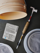 Bucket with water treatment components on a dark surface