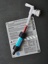 Water filtration system components on a grey surface with labels and instructions.