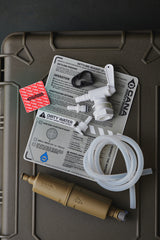 water filter components on a green case with labels and hoses