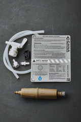Water filtration system components on a dark surface with a label.
