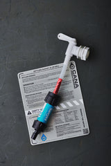 Water filtration components with a filter and tubing against a dark background