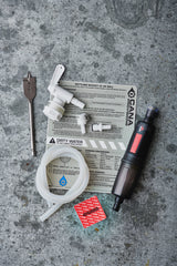 Collection of tools and equipment on a concrete surface with water filter