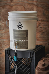 White bucket with a black logo on a wooden background