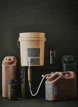 Collection of various water containers including a beige bucket, dark bottles, and tan and green jerry canisters on a dark background
