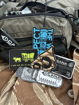 Collection of tactical stickers on a green bag