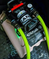 cana provisions ar-1 system with hoses attached on top of a tan water jerry can and with a cana provisions decon kit in the trunk of a vehicle